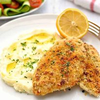Super Quick Chicken Dinner of crunchy broiled / grilled chicken, mashed potato and side salad on a white plate, ready to be eaten.
