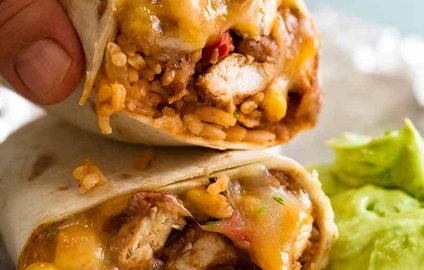 Hand picking up Chicken Burrito